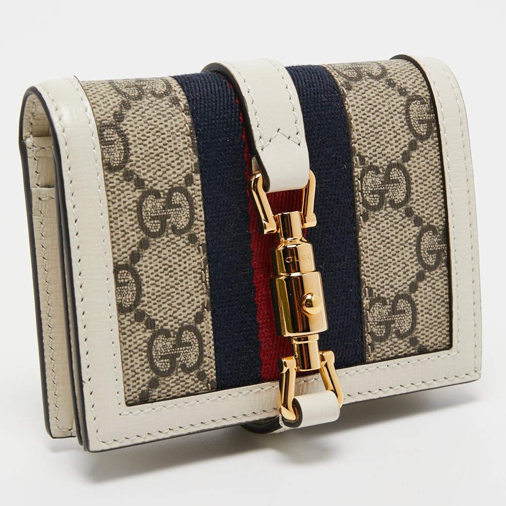 Wallets like this one from Gucci are a necessity since they're not only functional but also stylish. Crafted from GG Supreme canvas and adorned with a signature lock, this compact wallet has gold-tone accents.

