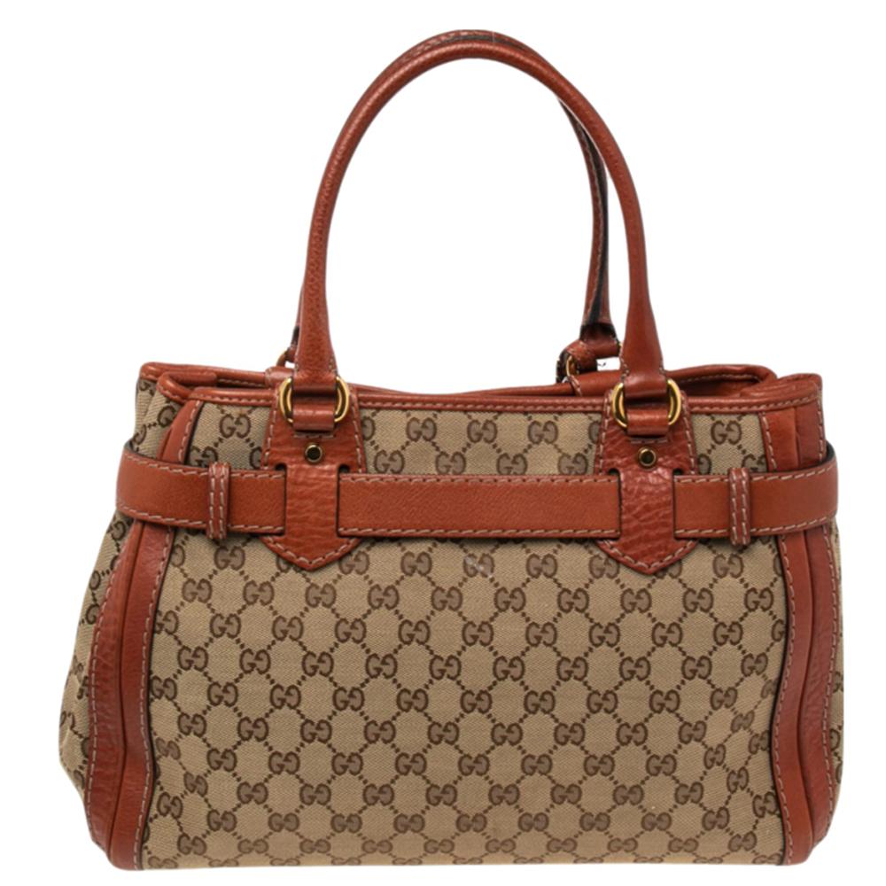 This Gucci Running tote is made of GG canvas and leather. It features two handles, gold-tone hardware, and a spacious interior to house all your daily essentials. The gold-tone GG logo on the front is another highlight.