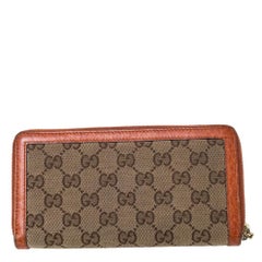 Gucci Beige/Orange GG Canvas and Leather Tassel Zip-around Continental Wallet