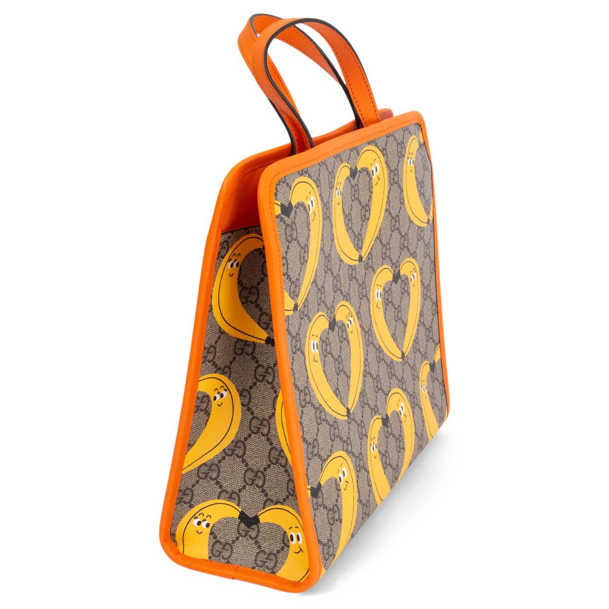 100% authentic Gucci banana heart printed handbag in grey, yellow, black, white and orange coated canvas. Opens with push button on top and is lined in orange nylon with one open pocket against the back. Brand new. 

Measurements
Height	25cm