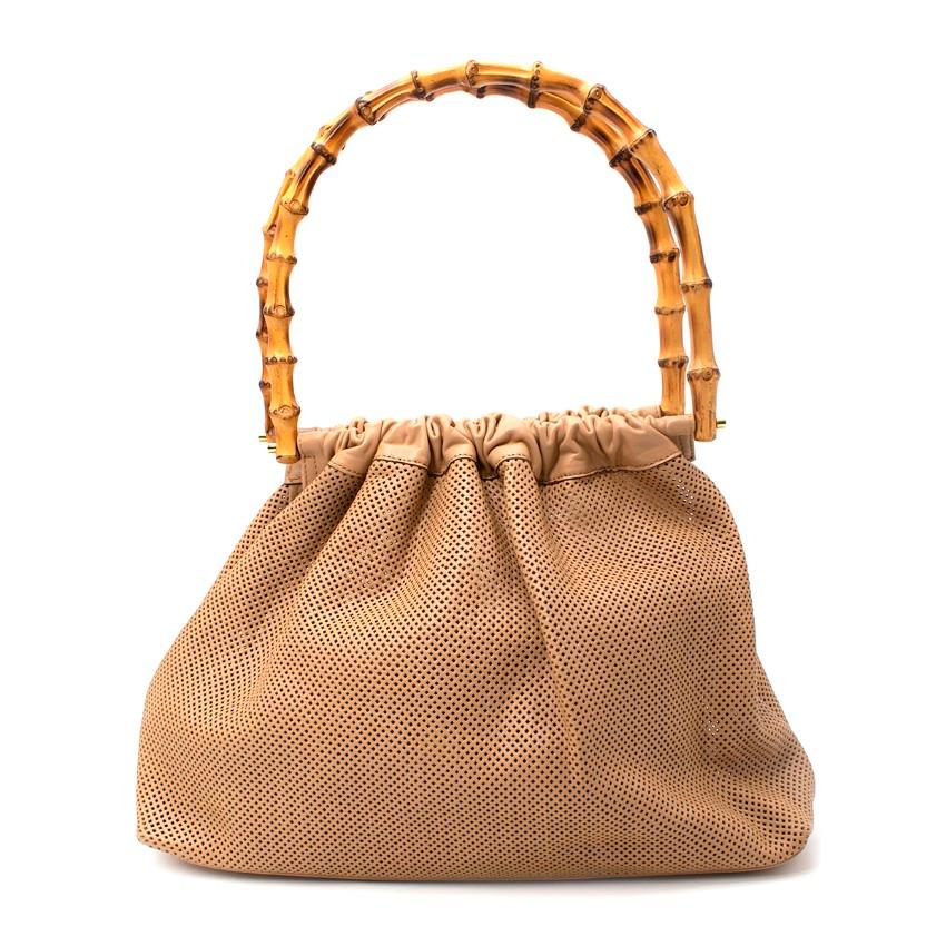 Gucci Beige Perforated Leather Bamboo Top Handle Bag
 

 - Perforated leather soft body bag with iconic rounded bamboo top handle frame
 - One compartment with a tonal zip up pouch on a strap
 - Gold-tone hardware
 

 Materials:
 Leather
 

 Made in