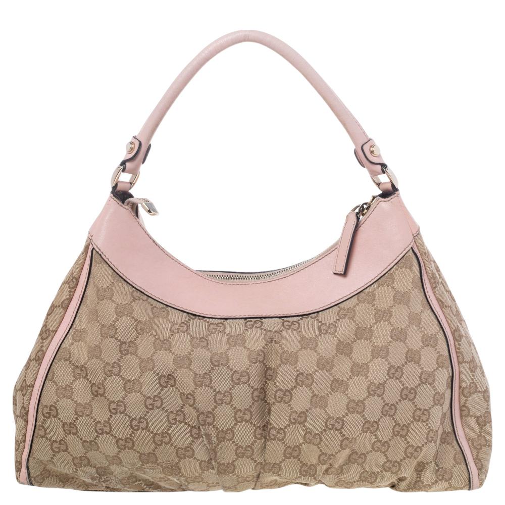 Gucci brings to you this amazing D Ring bag that is smart and modern. Made in Italy, it is crafted from classic GG canvas and features a single top handle. The top zipper reveals a canvas-lined interior with enough space to hold all your daily