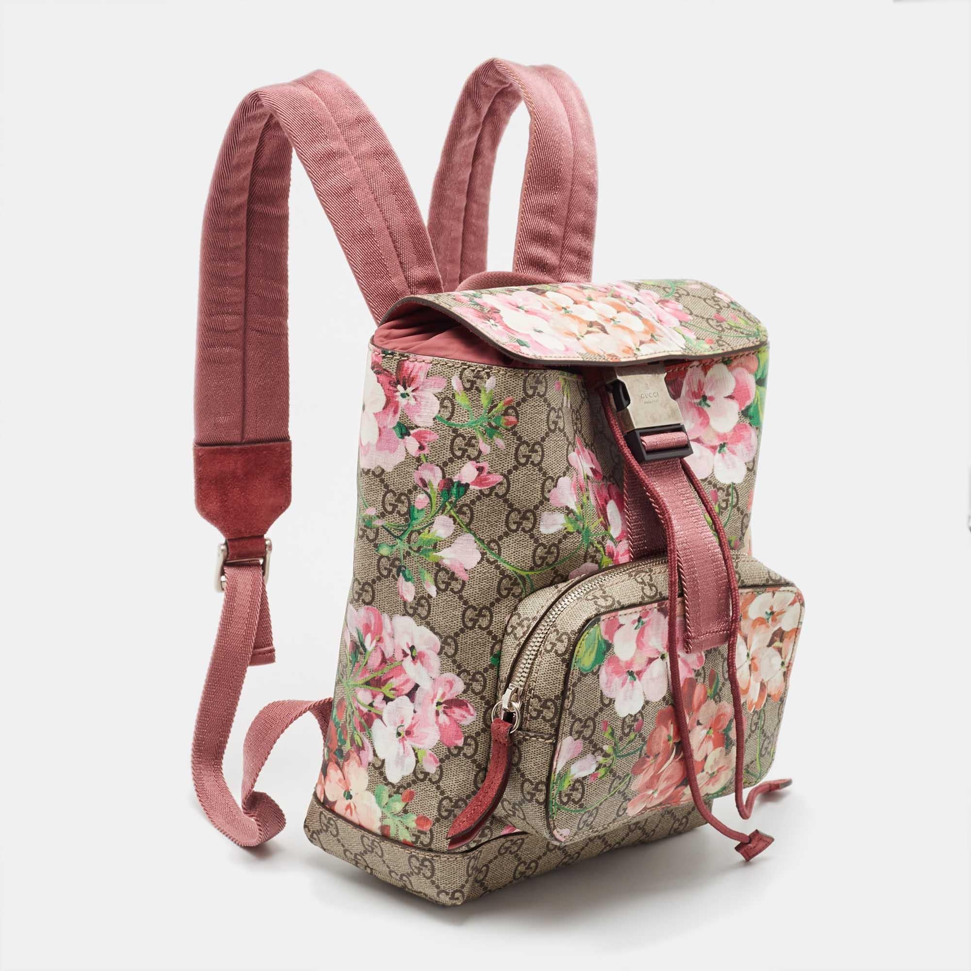 This stylish backpack from Gucci is made from signature GG Blooms Supreme canvas and is enhanced with leather trims. The bag features a zip pocket on the front and shoulder straps. It has a spacious interior that is lined with nylon. The simple