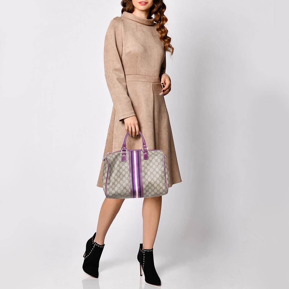 This handbag from the house of Gucci will reflect your fabulous choices. This Joy Boston bag is stylish, playful, and an absolute must-have. Crafted in Italy from GG coated canvas, it comes in a beige hue and is beautifully adorned with Web stripes