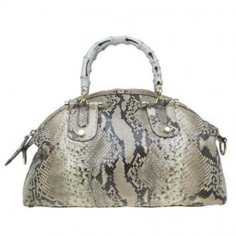 Ce sac à poignée en bambou de Gucci est cool et classe. Il est réalisé en cuir de python dans une teinte beige et est agrémenté de deux poignées incurvées en bambou et de détails en métal doré. La fermeture à glissière sur le dessus ouvre sur un