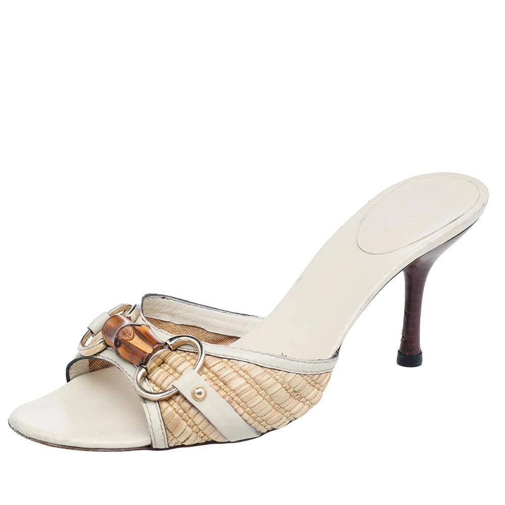 These Gucci slides are gorgeous from every angle. Made from raffia and leather, they feature open toes, gold-tone Horsebit detailing with bamboo accents, leather lining, and 8 cm heels to lift you.