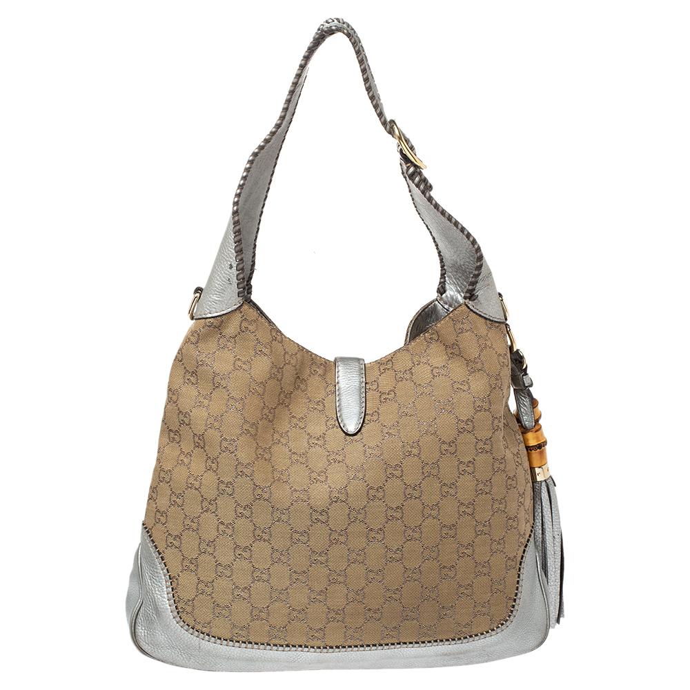 A handbag should not only be good-looking but also durable, just like this pretty New Jackie hobo from Gucci. Crafted from beige GG canvas and silver leather, this gorgeous number has the signature closure that opens up to a spacious canvas