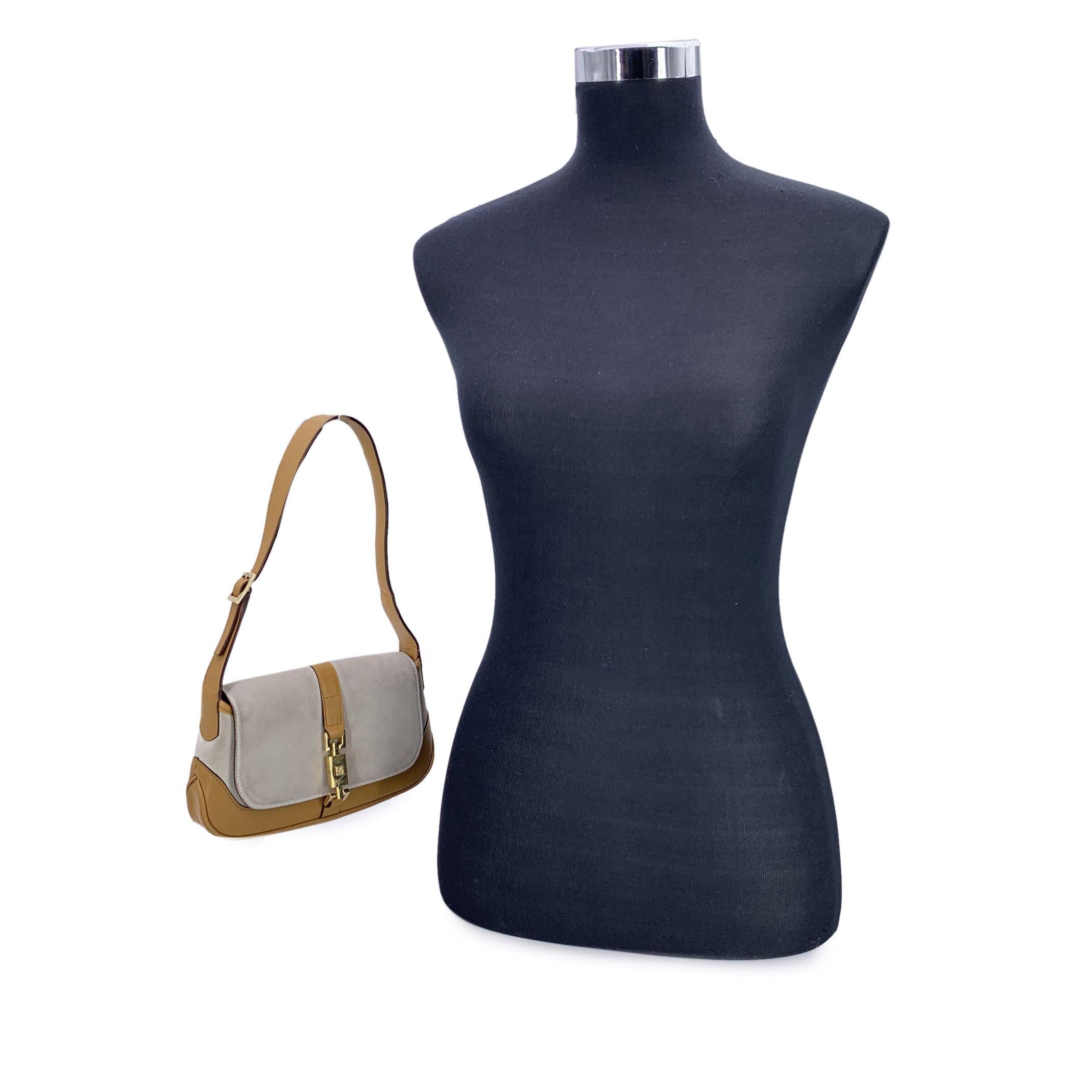 Step into a pivotal moment in fashion history with this rare Gucci Jackie flap bag, reimagined by Tom Ford for the brand's Fall/Winter 2000 collection. A true product of the era's bold elegance, this model features the distinctive flattened piston