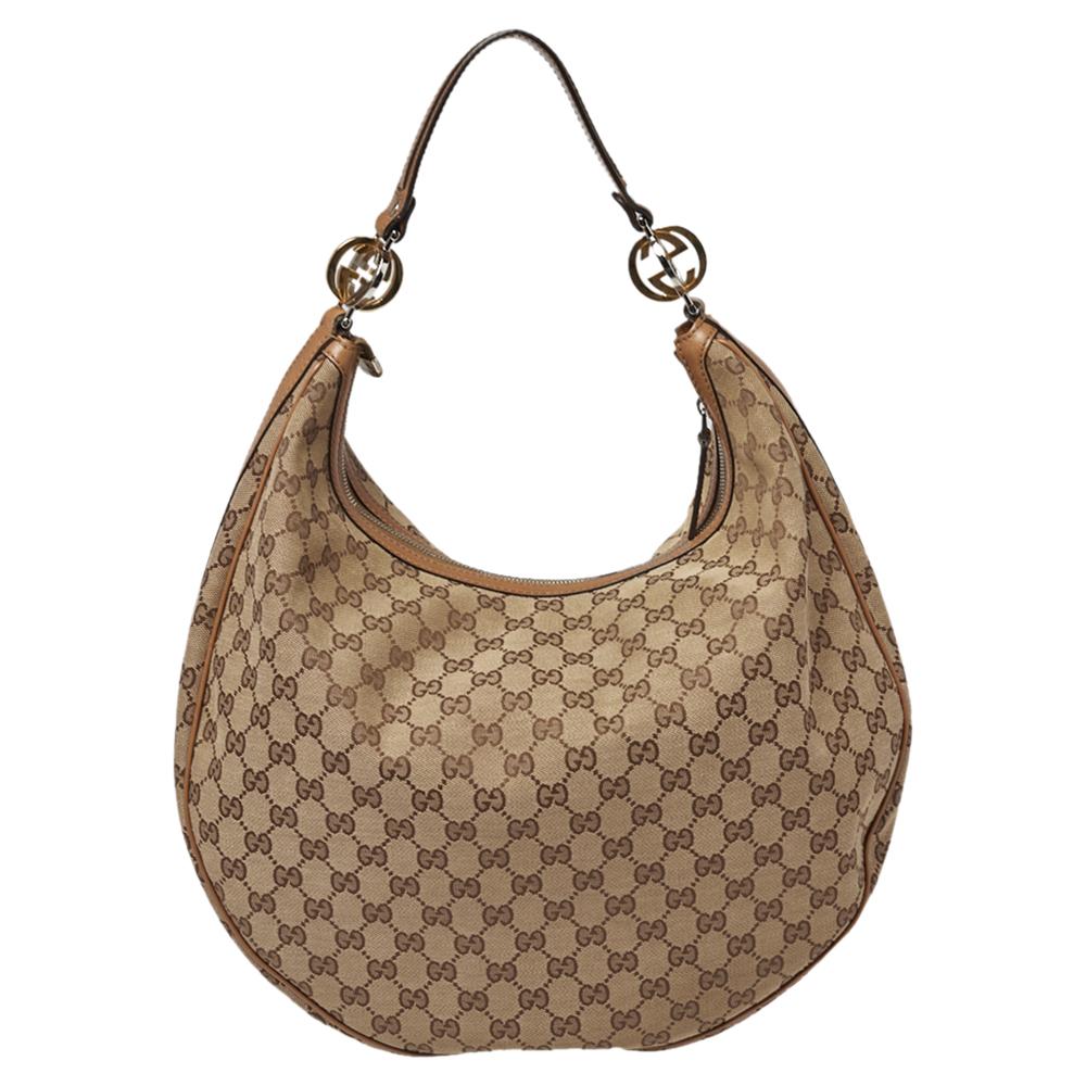 Good-looking, as well as durable, is this pretty Twins hobo from Gucci. Crafted from the signature canvas and leather in Italy, this gorgeous number has a top zip closure that opens up to a spacious fabric interior. Complete with a single handle