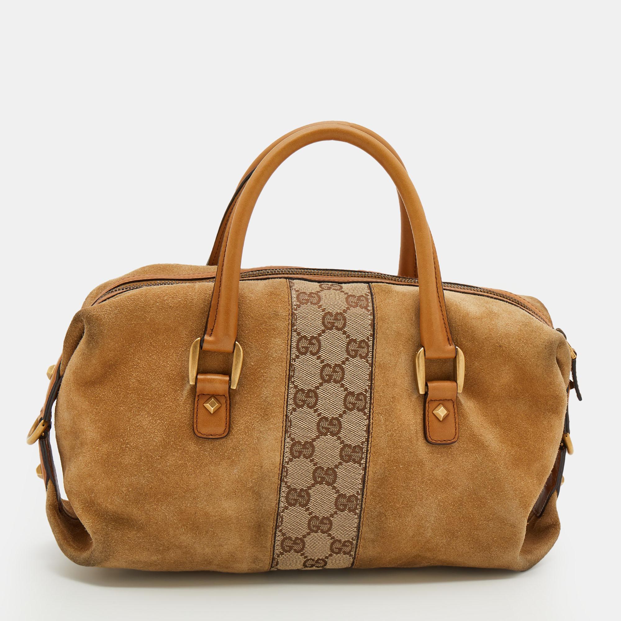 Get style and carry your essentials with ease using this Gucci Boston bag. It has been crafted from GG canvas, tan suede, and gold-tone hardware. The bag has two short handles and a spacious fabric interior.

Includes: Original Dustbag