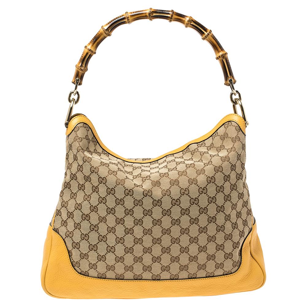 Invest in this timeless creation from the house of Gucci. Sophisticated and elegant, this shoulder is made from GG canvas and leather into a slouchy, relaxed shape. This stylish bag comes with a bamboo handle and a detachable shoulder strap for