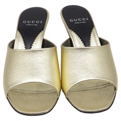 Gucci Bella Heeled Mules in Metallic Gold Leather