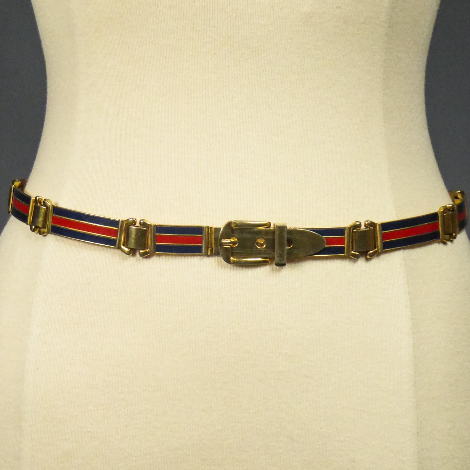Circa 1980
Italy

Fine Vintage belt in brass and enamel with the logo of the famous colors of the Gucci House Designer of Florence in Italy and dating from the 1980s. Shiny polished golden brass with long enamelled links with red and navy blue