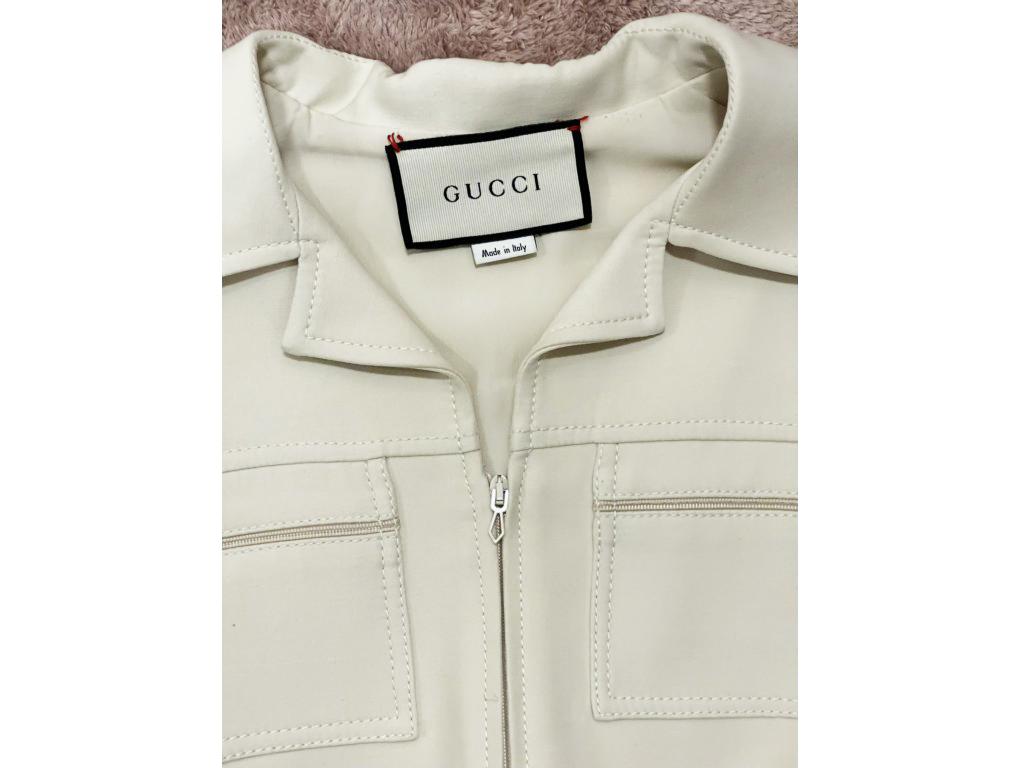 This Gucci’s ’70s-style playsuit is made from wool and silk-blend and has a removable ‘GG’ belt. A new item for sale, never worn.

BRAND	
Gucci

FEATURES	
Concealed zip fastening along front, removable 'GG' belt, zipped pockets

MATERIAL	
51% wool,