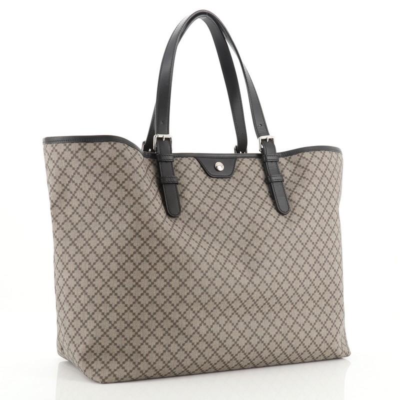 This Gucci Belted Tote Diamante Coated Canvas Large, crafted in neutral diamante coated canvas, features adjustable dual flat leather handles and silver-tone hardware. It opens to a neutral fabric. 
Estimated Retail Price: $1,100
Condition: