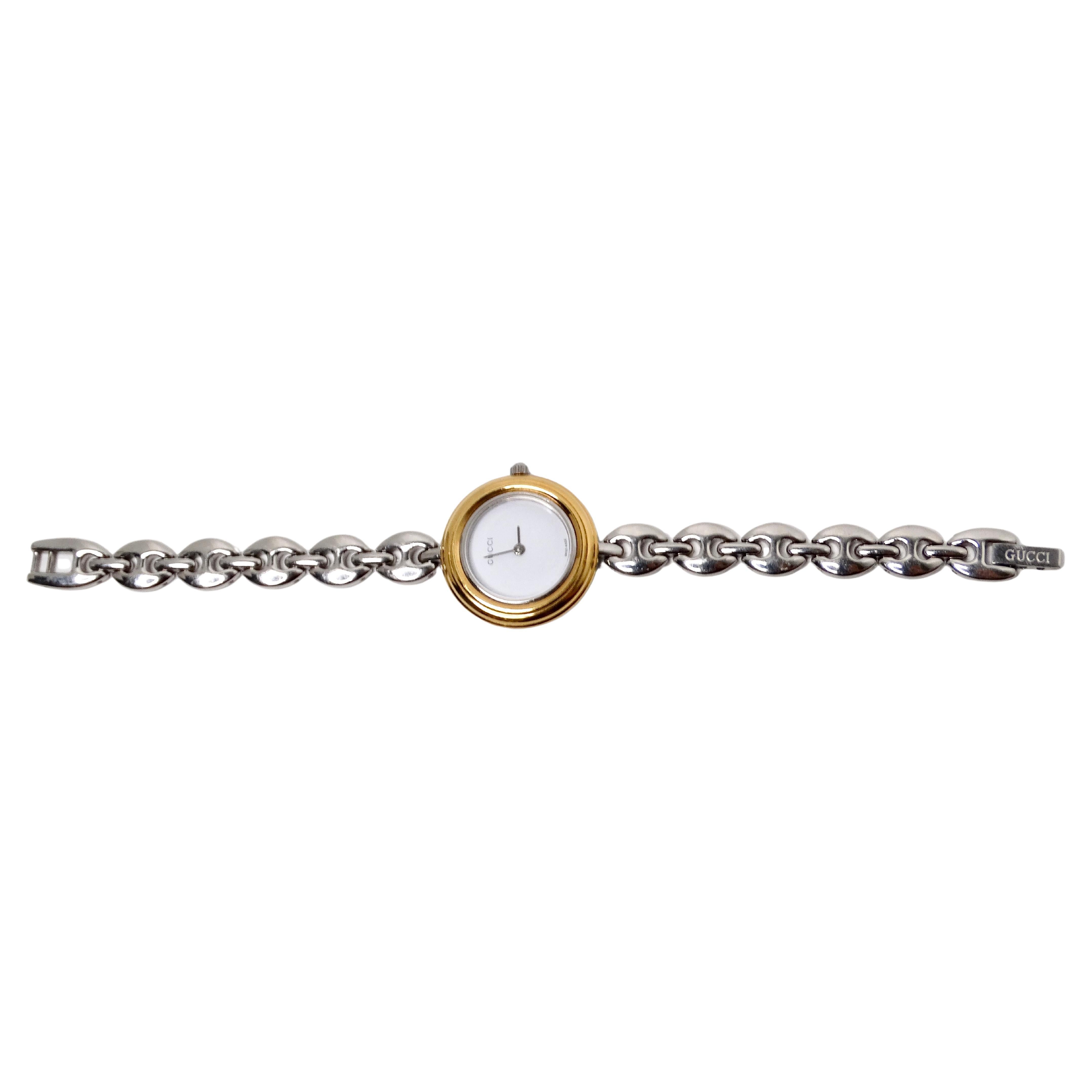 The Gucci Bezel Color Interchangeable Chain Link Wrist Watch & Set from the 1990s is a stunning and versatile designer piece that exemplifies the brand’s signature luxury and innovative craftsmanship. Crafted in gold plating & stainless steal, this