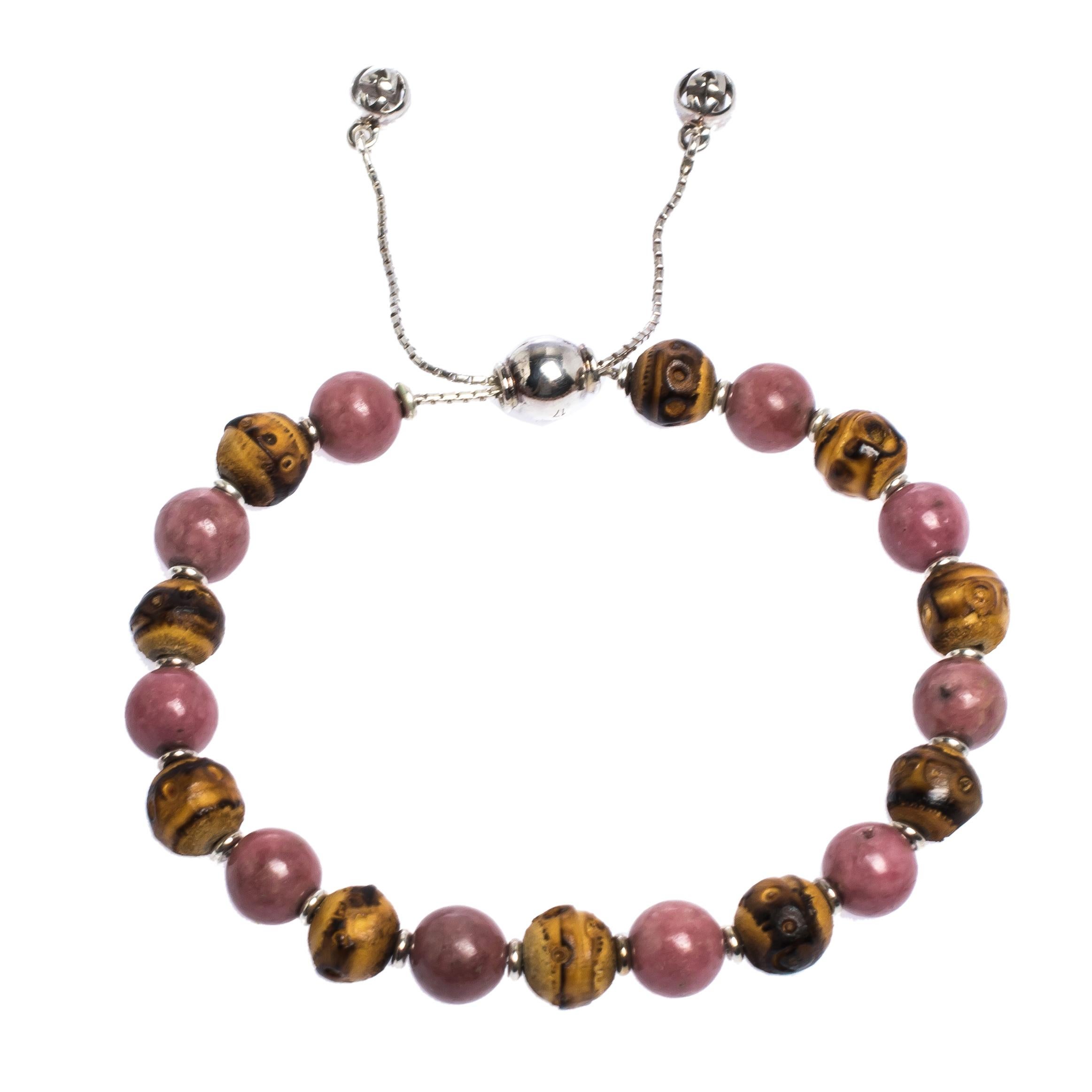 Simplicity and fashion combine to form this exquisite Gucci bracelet just for you. Made from silver, the bracelet features a string of stone and wood beads and an adjustable closure. Minimal and comfortable to wear, this piece will make a fine