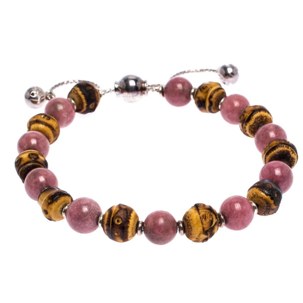 Simplicity and fashion combine to form this exquisite Gucci bracelet just for you. Made from silver, the bracelet features a string of stone and wood beads and an adjustable closure. Minimal and comfortable to wear, this piece will make a fine