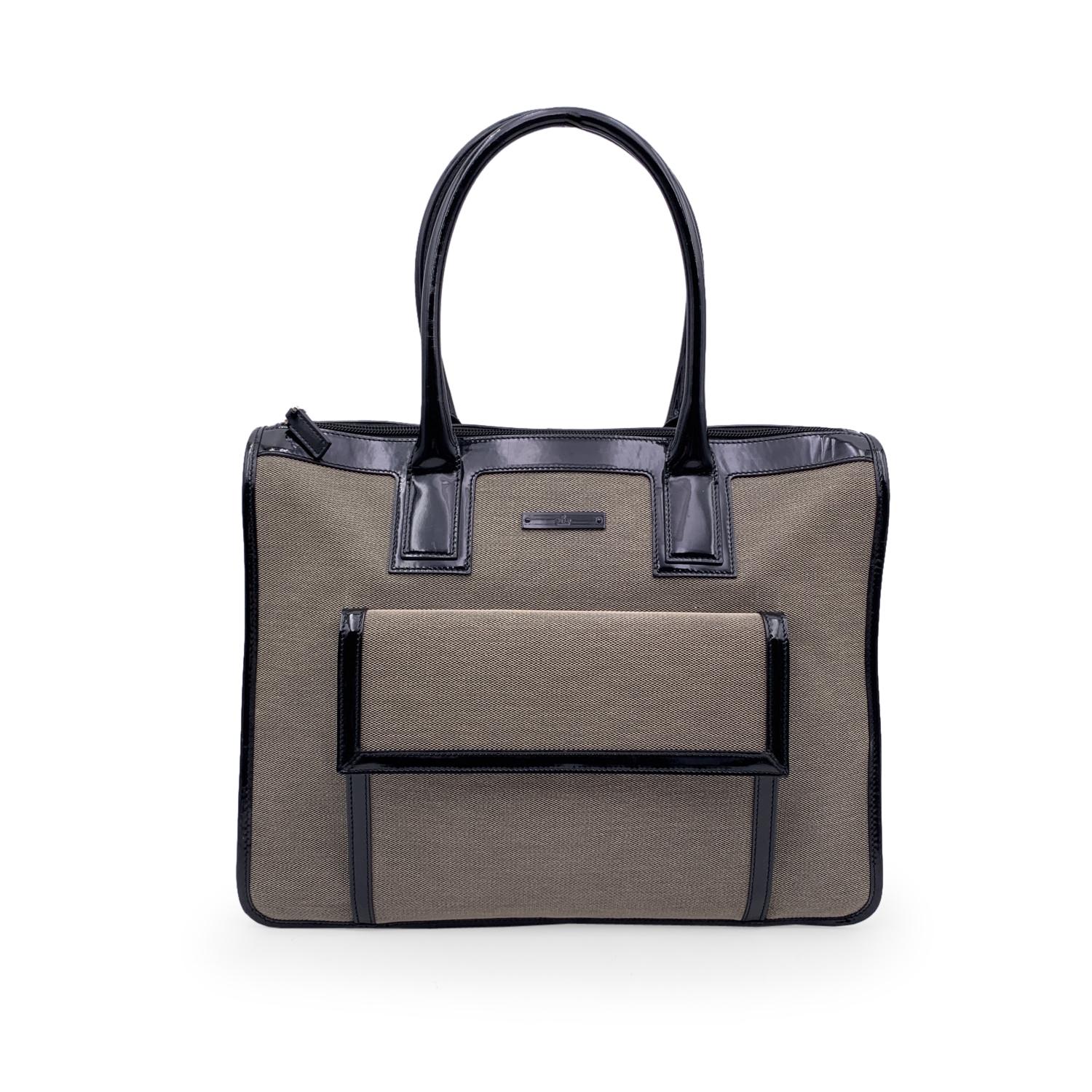 Beautiful Gucci satchel, crafted in beige canvas with black patent leather trim and handles. Front flap pocket. Upper zipper closure. Black fabric lining. 1 side zip pocket inside. 'Gucci - Made in Italy ' and serial number engraved