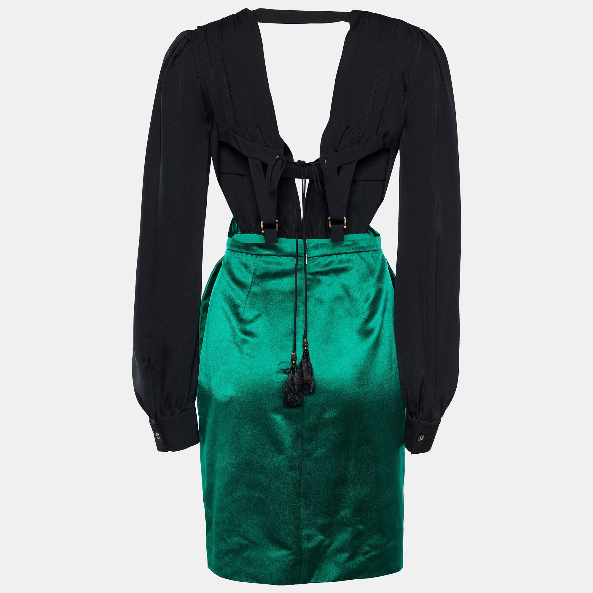 Gucci is acing its style game with this magnificent dress, and we are loving it! Covered in black and emerald green hues, this silk silhouette flaunts an audacious backless style with cut-out detailing, making it the perfect party attire. Two