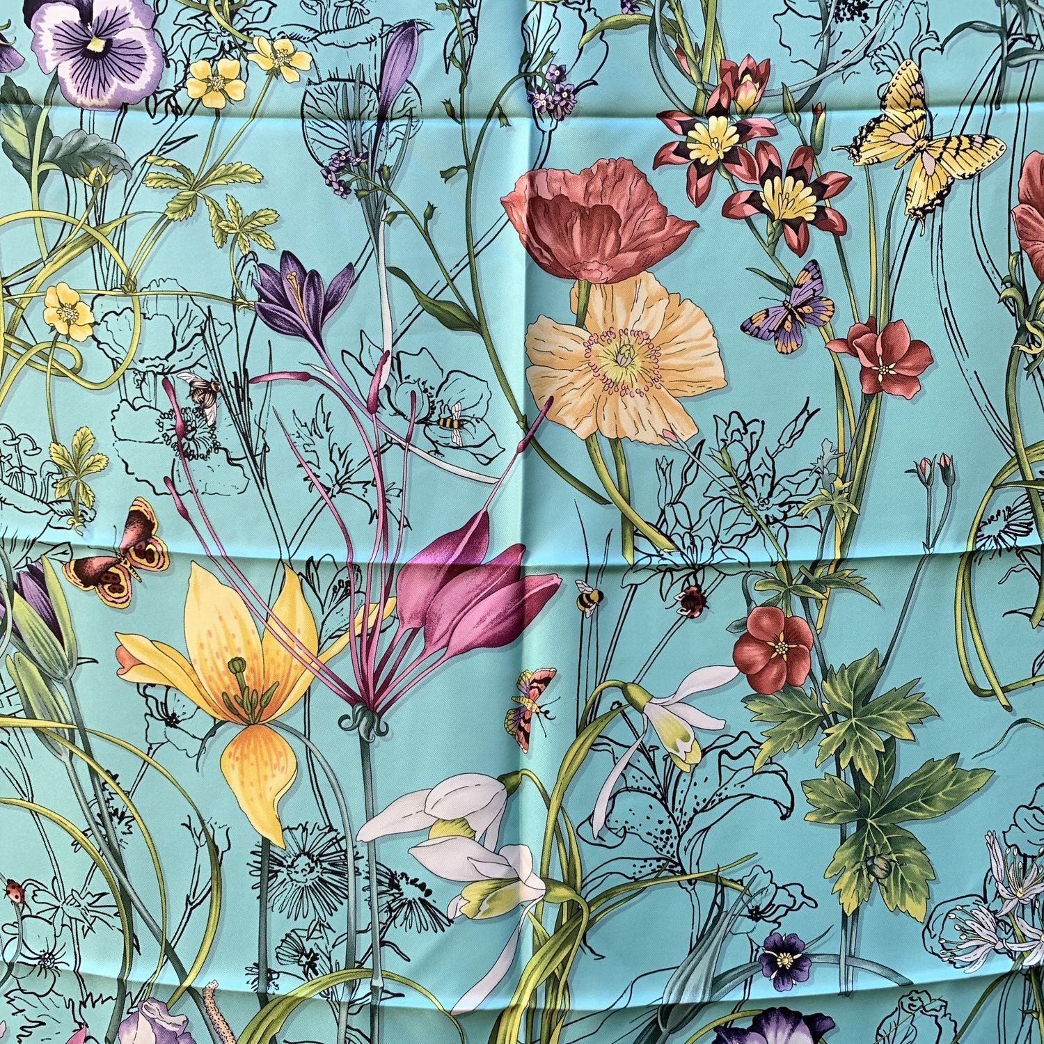 Gucci silk 'Flora Infinity Chrissy' scarf. It features a multicolored fòloral design on turquoise background and black borders. Measurements. 34 x 34 inches - 86.4 x 86. cm. Made in Italy Condition A - EXCELLENT In excellent condition. Gucci box