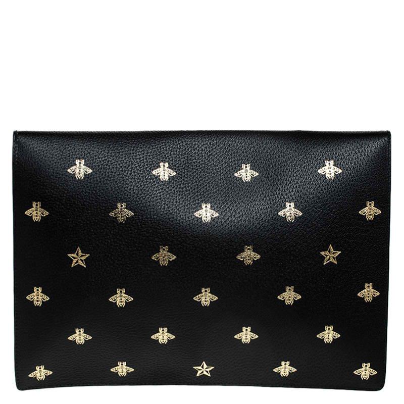 This Portfolio clutch from the house of Gucci is a must-have accessory to complement your look. Enhanced with black color, this stylish bag is all you need to flaunt your style this season. it is adorned with gold bee motifs all over and an