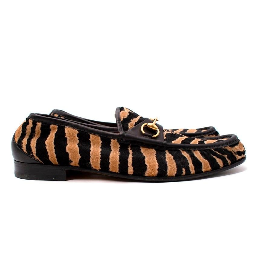  Gucci Black & Beige Tiger Print Horsebit Loafer
 

 - Ponyhair upper in black and beige zebra pattern
 - Black leather trimming and heel
 - Gold-tone horsebit hardware to the toe
 - Tan leather lining 
 

 Materials:
 Leather
 

 Made in Italy
 

