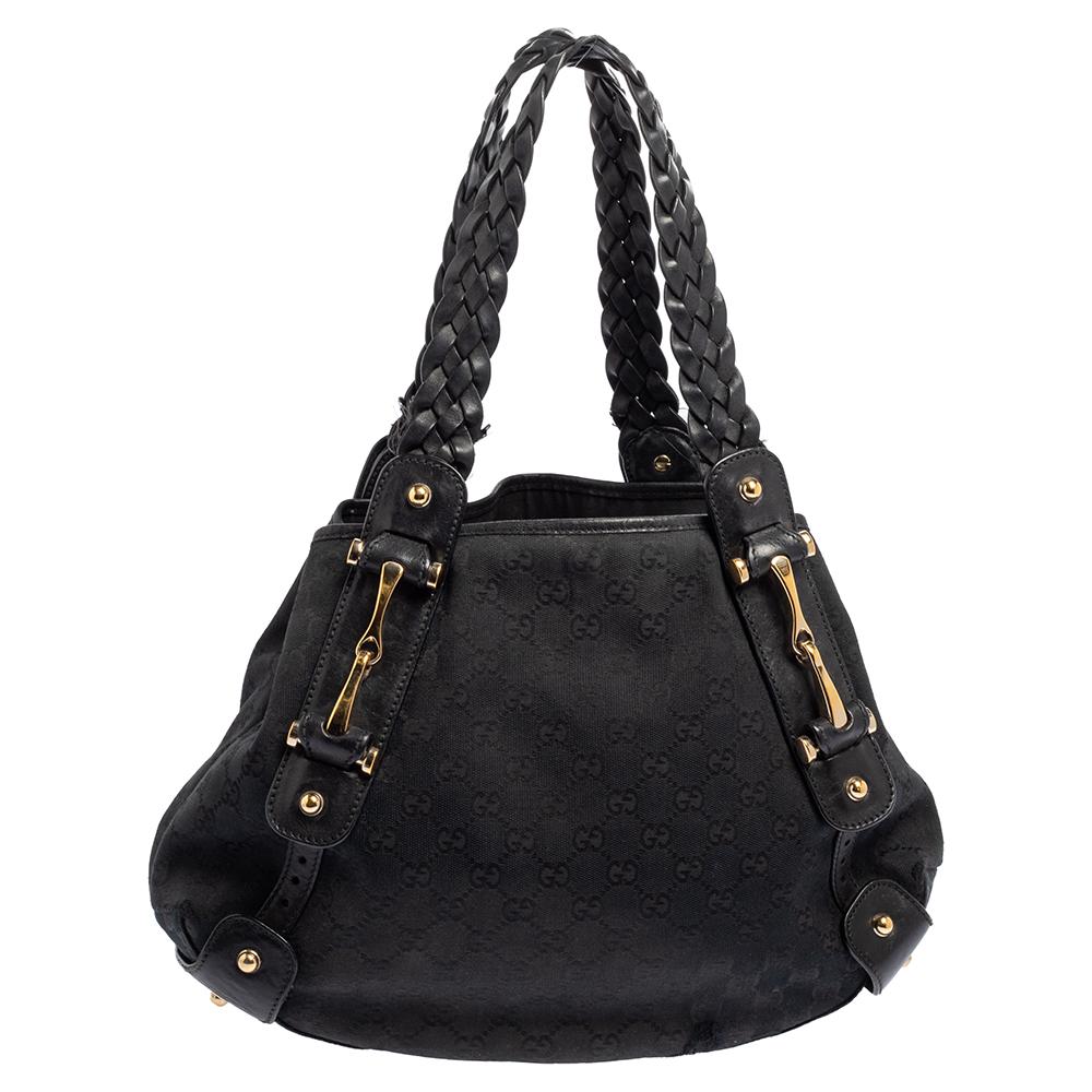 Take your style a notch higher with this Pelham hobo from Gucci. Cut out from GG canvas & leather, the bag features two braided leather handles, a spacious fabric interior and protective metal feet. This hobo is perfect for daily use.

