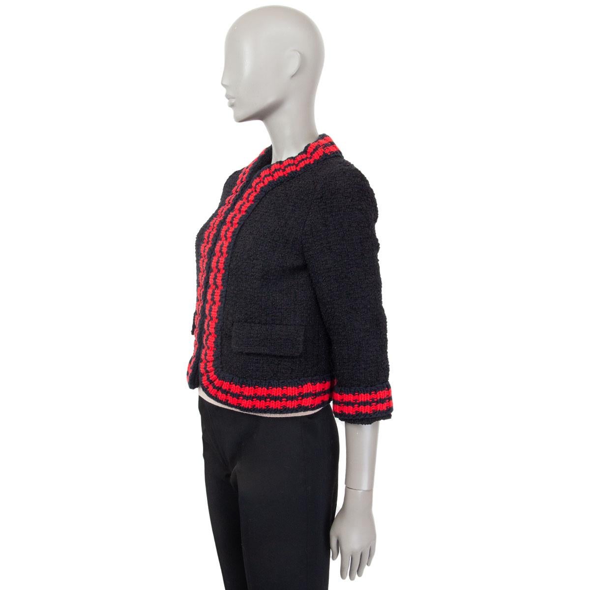 authentic Gucci bouclé-tweed cropped jacket in black polyamide (79%), cotton (11%), acrylic (10%) with contrasting red and navy ribbed wool-blend trimming in viscose (50%) and metal fibre (50%). Lined in light grey satin acetate (52%) and  viscose