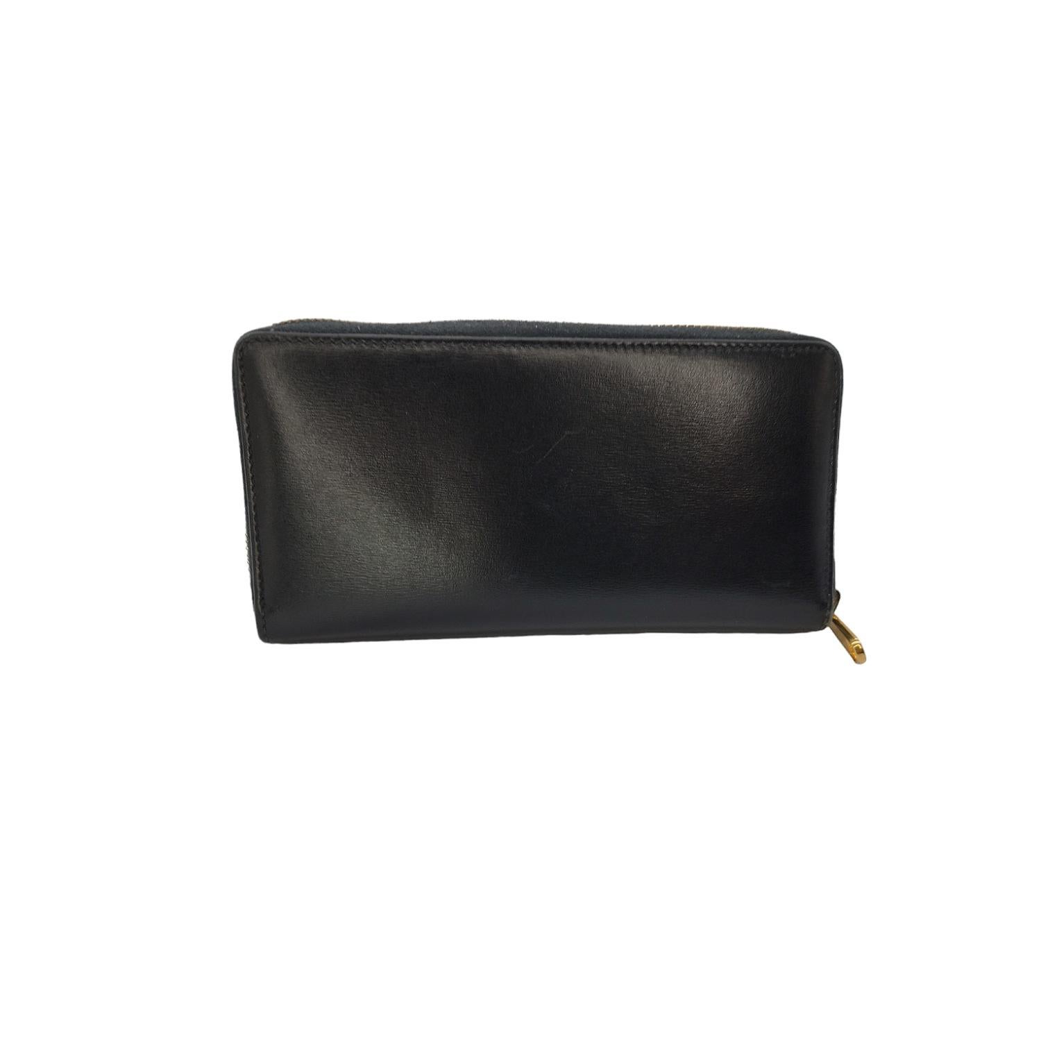 This stylish wallet is crafted of smooth leather in black with a 3/4 wrap around zipper that opens to a leather and fabric interior with plenty card slots, compartments, and pockets. The horsebit design is an iconic detail that is part of Gucci's