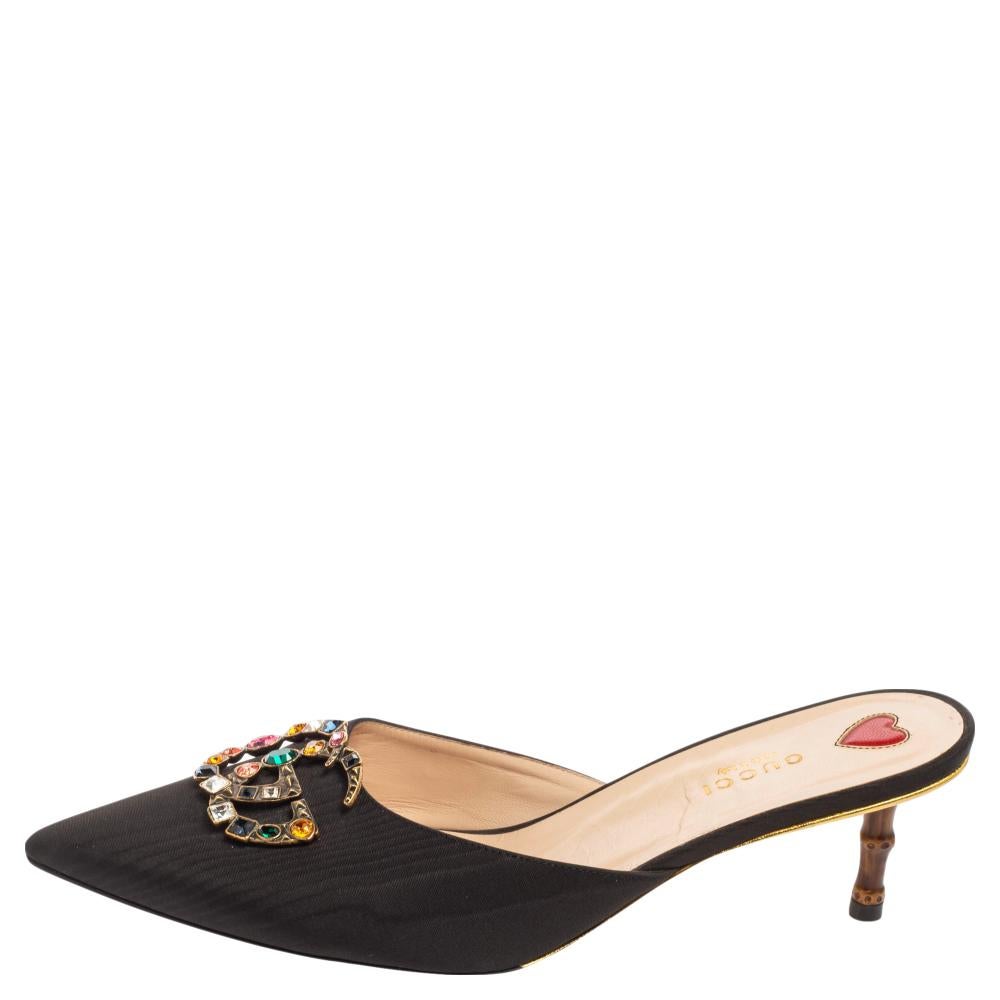 Featuring signature elements with a chic silhouette, these Unia mule sandals from the House of Gucci bring your feet timeless beauty and iconic excellence. They are made from black canvas, with a crystal-embellished GG motif attached to their upper.