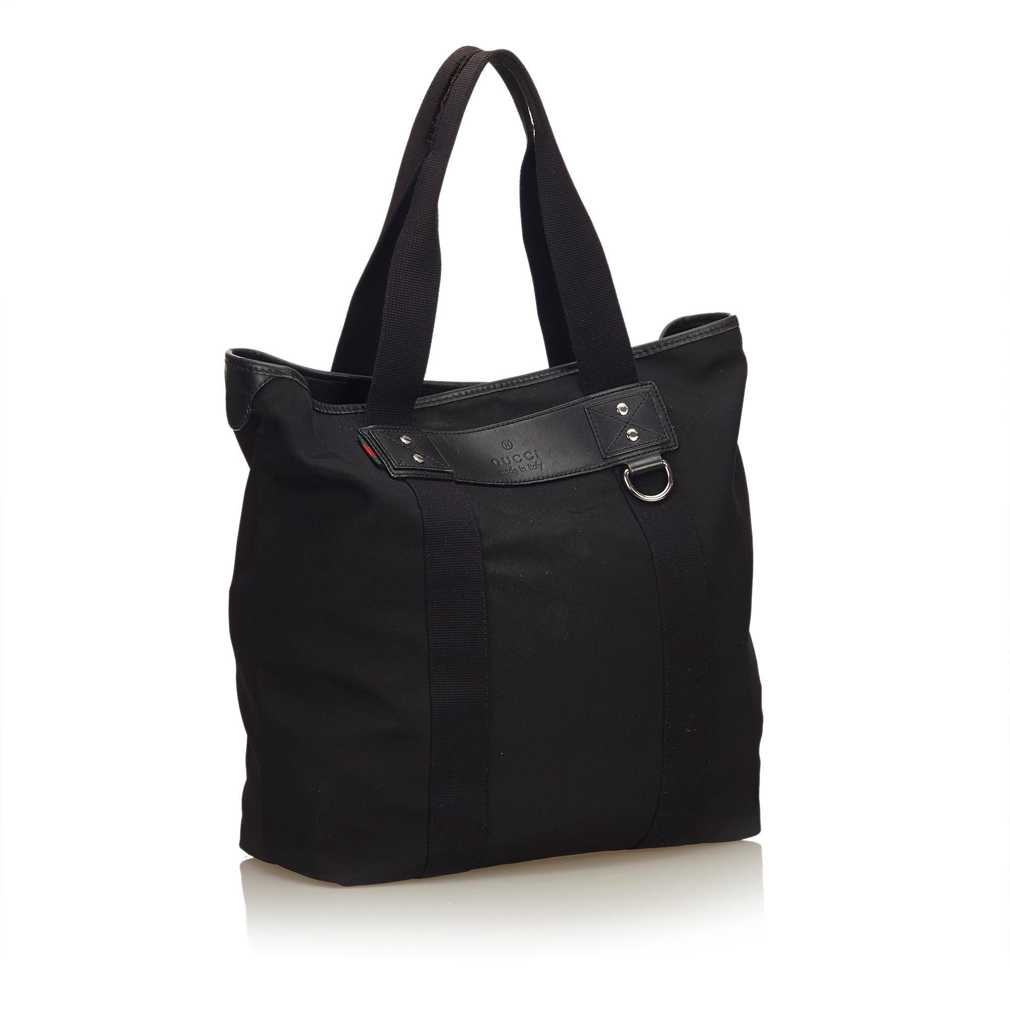 This tote bag features a canvas body with leather trim, flat straps, open top, and interior zip and slip pockets. It carries as AB condition rating.

Inclusions: 
This item does not come with inclusions.

Dimensions:
Length: 35.00 cm
Width: 40.00