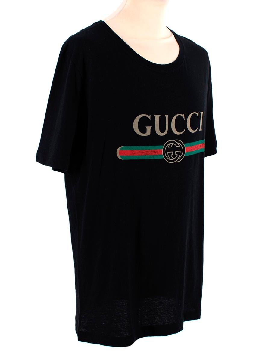 Gucci Black Cotton Jersey Fake Logo T-Shirt
 

 - Crew neck, short sleeve cotton jersey
 - 'Fake' logo on the chest in gold, red and green
 - Oversized silhouette
 

 Materials 
 100% Cotton 
 

 Made in Italy 
 Wash on reverse 
 

 PLEASE NOTE,