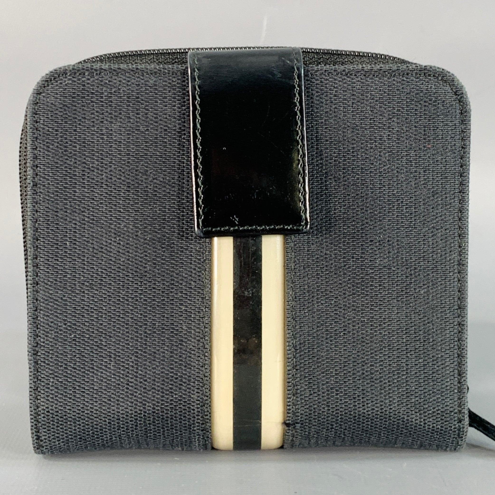 GUCCI Brieftasche
aus schwarzem Canvas mit cremefarbenem und schwarzem Streifendesign, Innenausstattung aus schwarzem Lackleder mit mehreren Kartenfächern und Druckknopfverschluss mit Münzfach mit Reißverschluss. Made in Italy. sehr guter