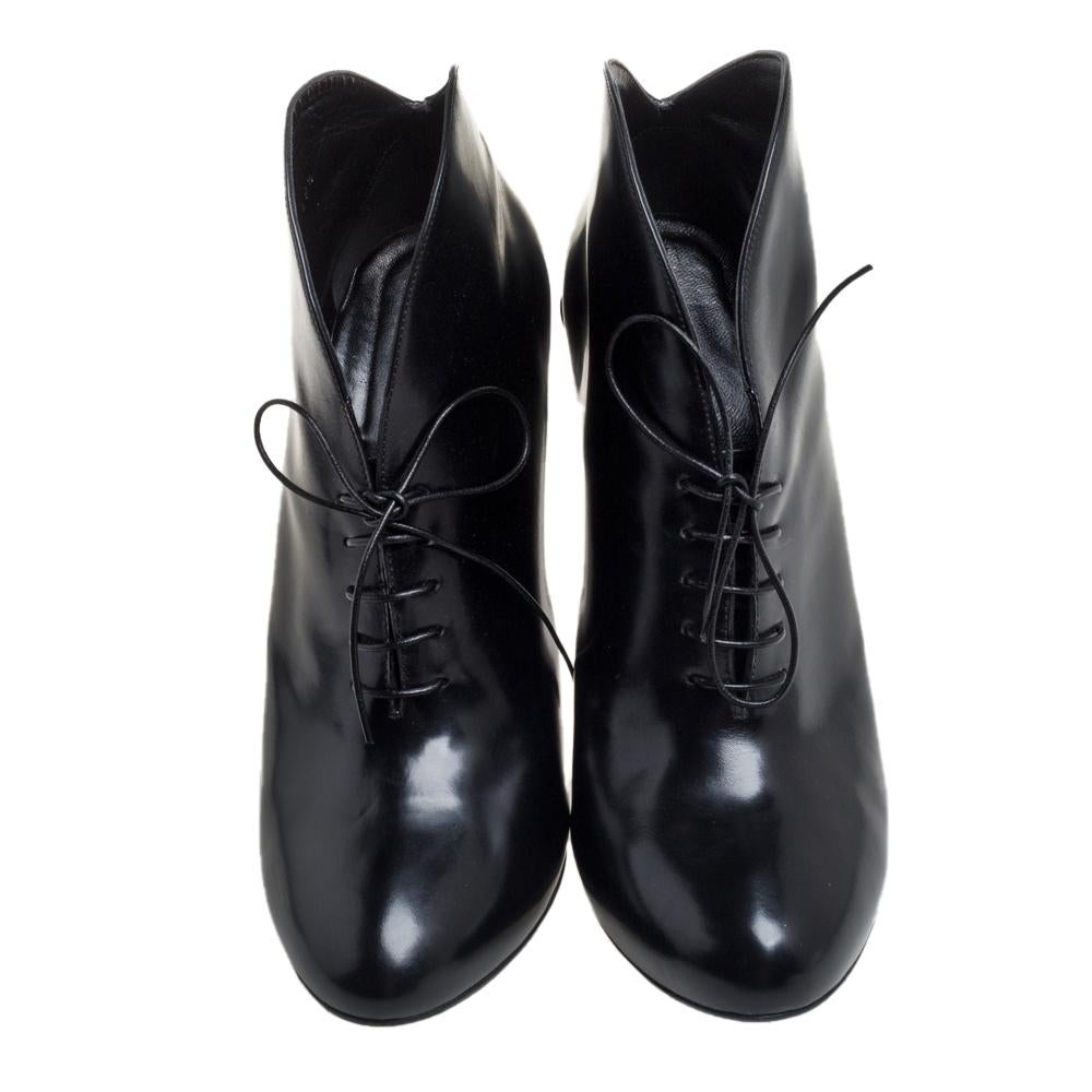These Kim ankle boots from Gucci are totally chic and stylish! They are crafted from black leather and designed with almond toes, lace-ups on the vamps, and curved toplines. They are endowed with comfortable leather-lined insoles and elevated on 12