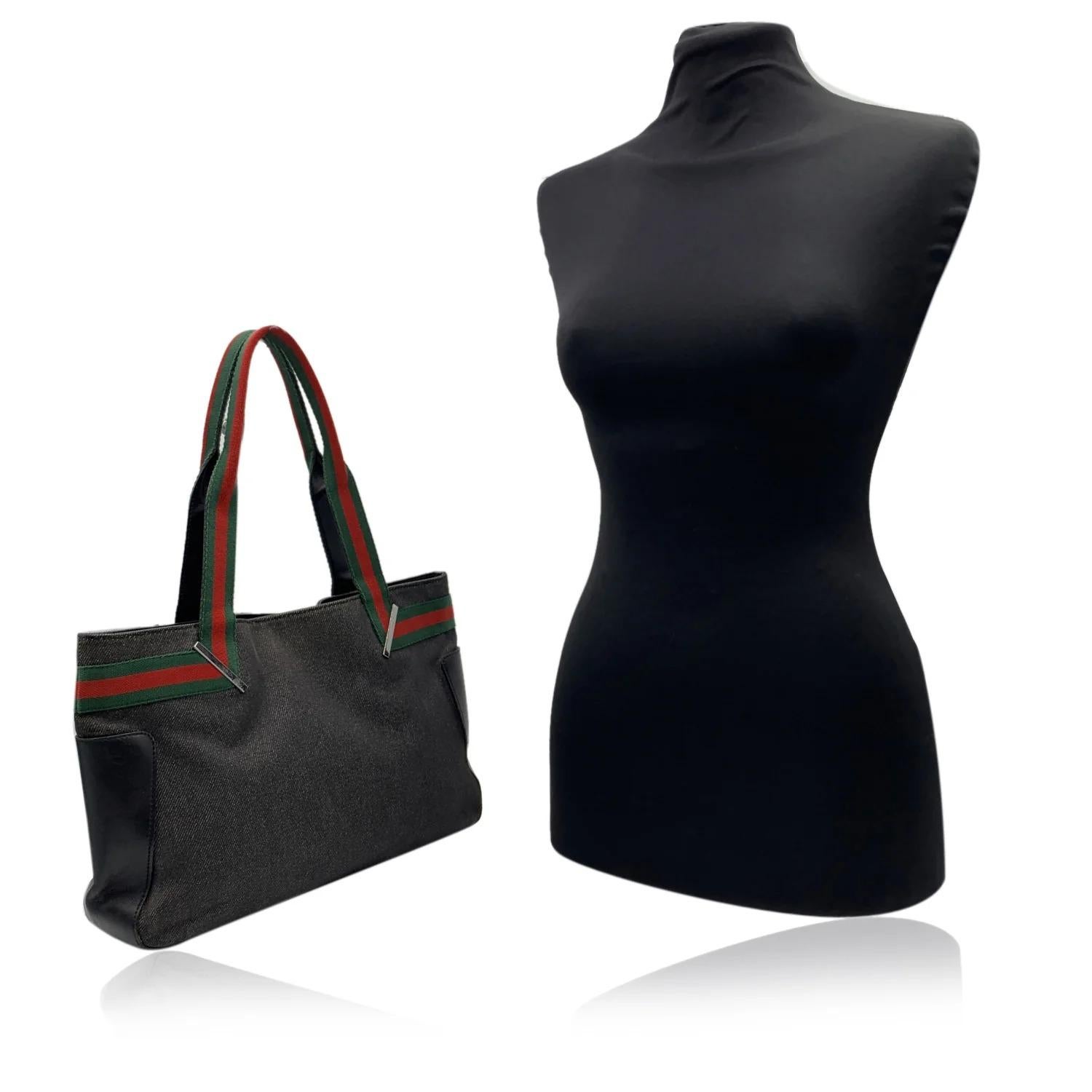 Beautiful Gucci black denim canvas tote. Green/Red/Green striped detailing on the front, on the back and on handles. Black monogram lining. 1 side zip pocket inside. 'Gucci - Made in Italy' tag on the front. (serial number on its reverse). Details