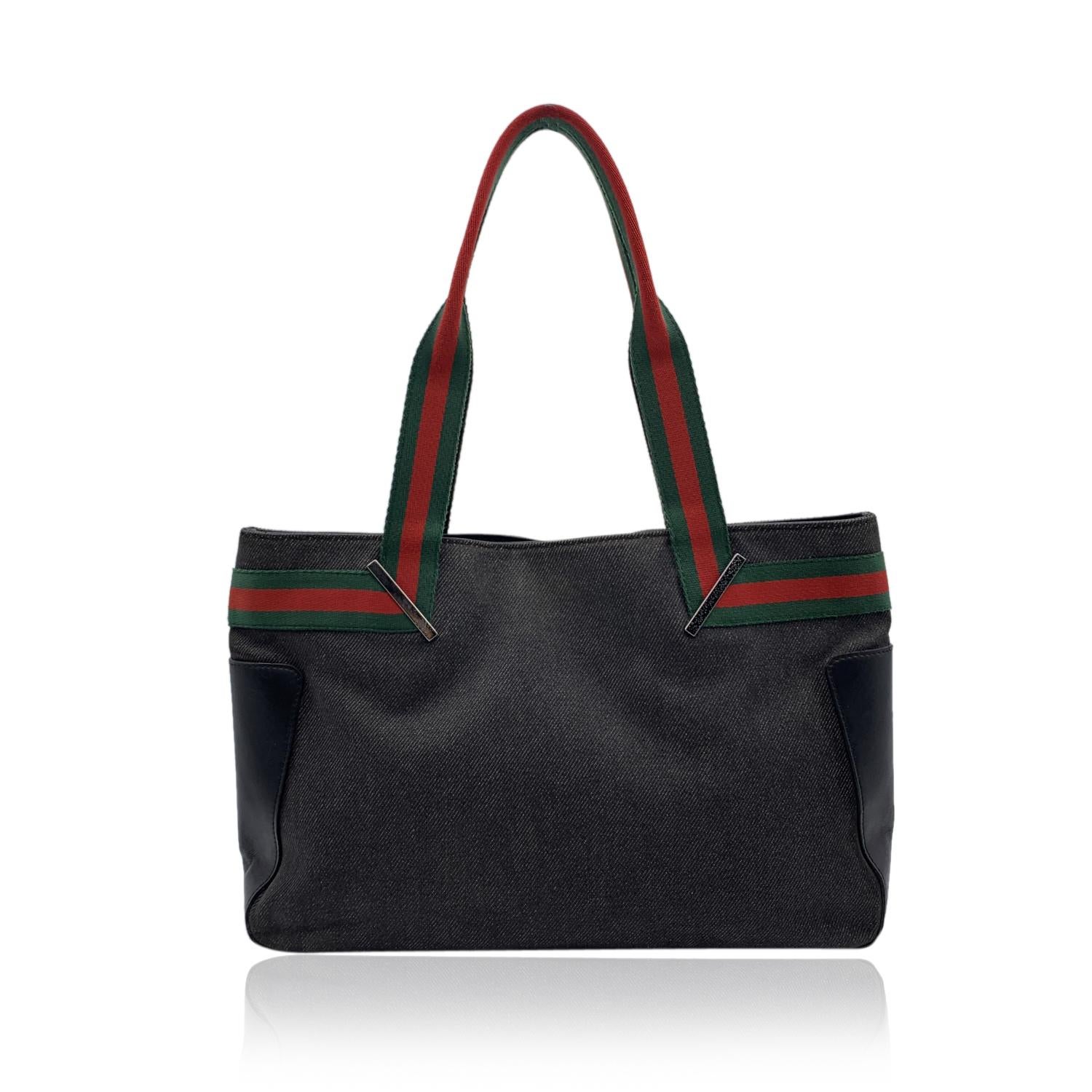 Beautiful Gucci black denim canvas tote. Green/Red/Green striped detailing on the front, on the back and on handles. Black monogram lining. 1 side zip pocket inside. 'Gucci - Made in Italy' tag on the front. (serial number on its