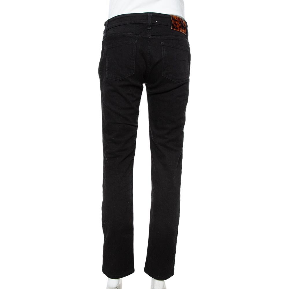 These slim-fit jeans from Gucci are unique and one of a kind. The black denim construction is enhanced with criss-cross lace and button details below the waist and the jeans are equipped with four pockets. They are sure to be a valuable addition to