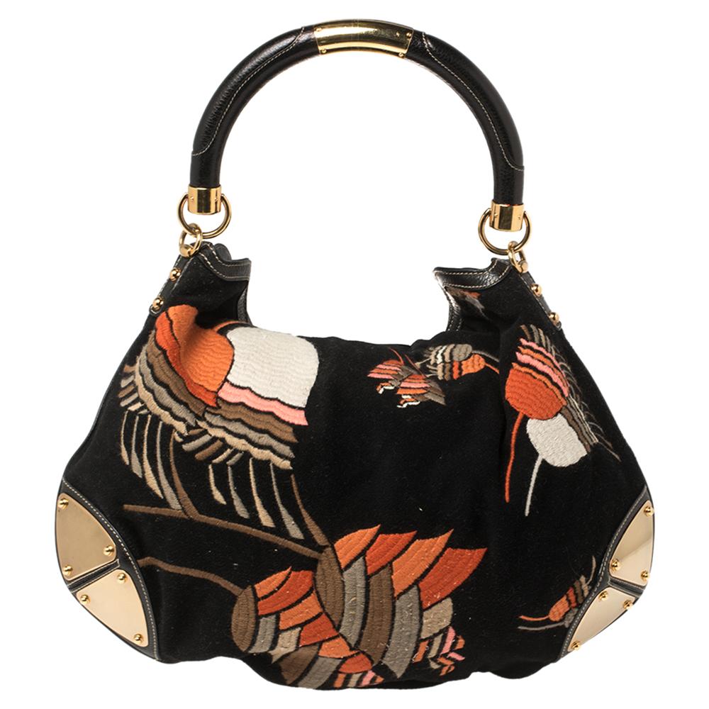 This Gucci Babouska Indy creation might just become the most loved classic bag in your closet. Crafted from felt and leather, it has embroidered details, armored corners, and the signature tassel detail dangling from the top. The bag is equipped