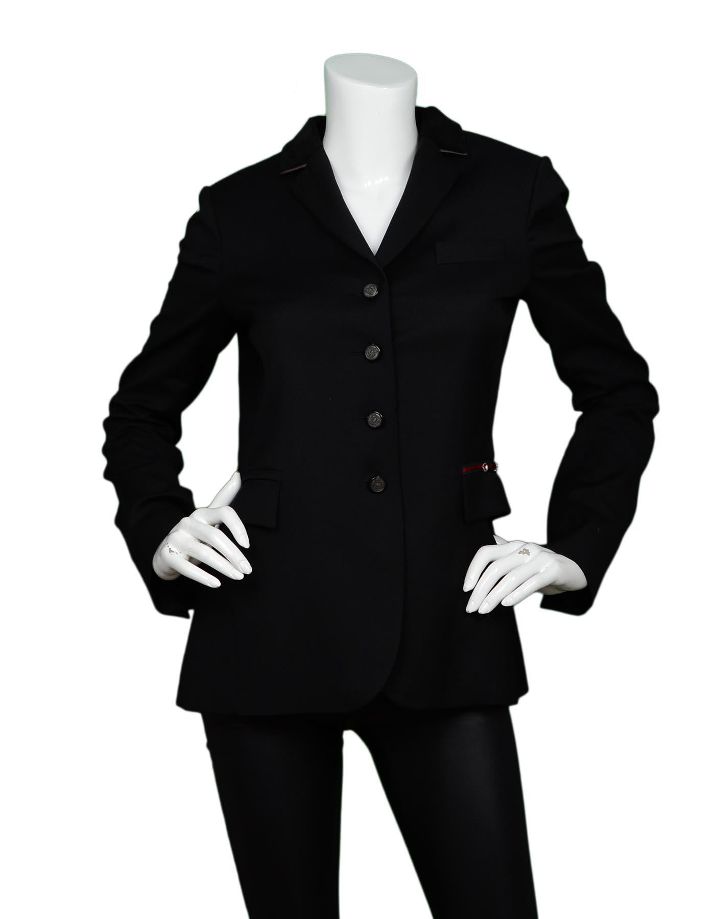 Gucci Black Equestrian Riding Jacket W/ Velvet & Web Trim Sz 42

Made In:   Italy
Color: Black
Materials: Fabric 1: 100% wool, Fabric 2: 74% cotton, 23% cotton, 3% elastane
Lining: 57% rayon, 43% polyester
Opening/Closure: Button front
Overall