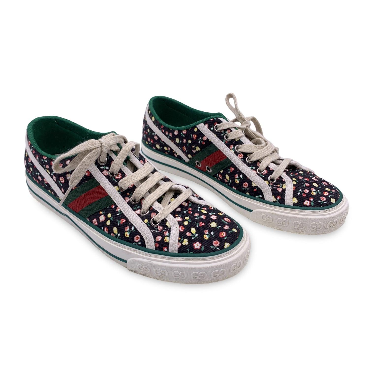 Gucci 'Gucci Tennis 1977' sneakers. Low-top canvas sneakers in black featuring multicolor floral pattern. Round toe. Lace-up closure in beige. Logo patch on the tongue. Signature web stripes in red and green at sides. Jersey lining in green. Rubber