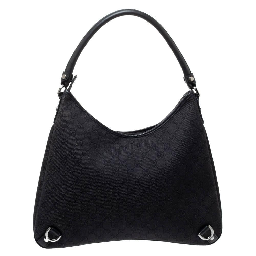 Gucci brings to you this amazing Abbey D-Ring hobo that is a classic. Made in Italy, this black bag is crafted from GG coated canvas and features a leather handle. It opens to a fabric-lined interior with enough space to hold all your daily