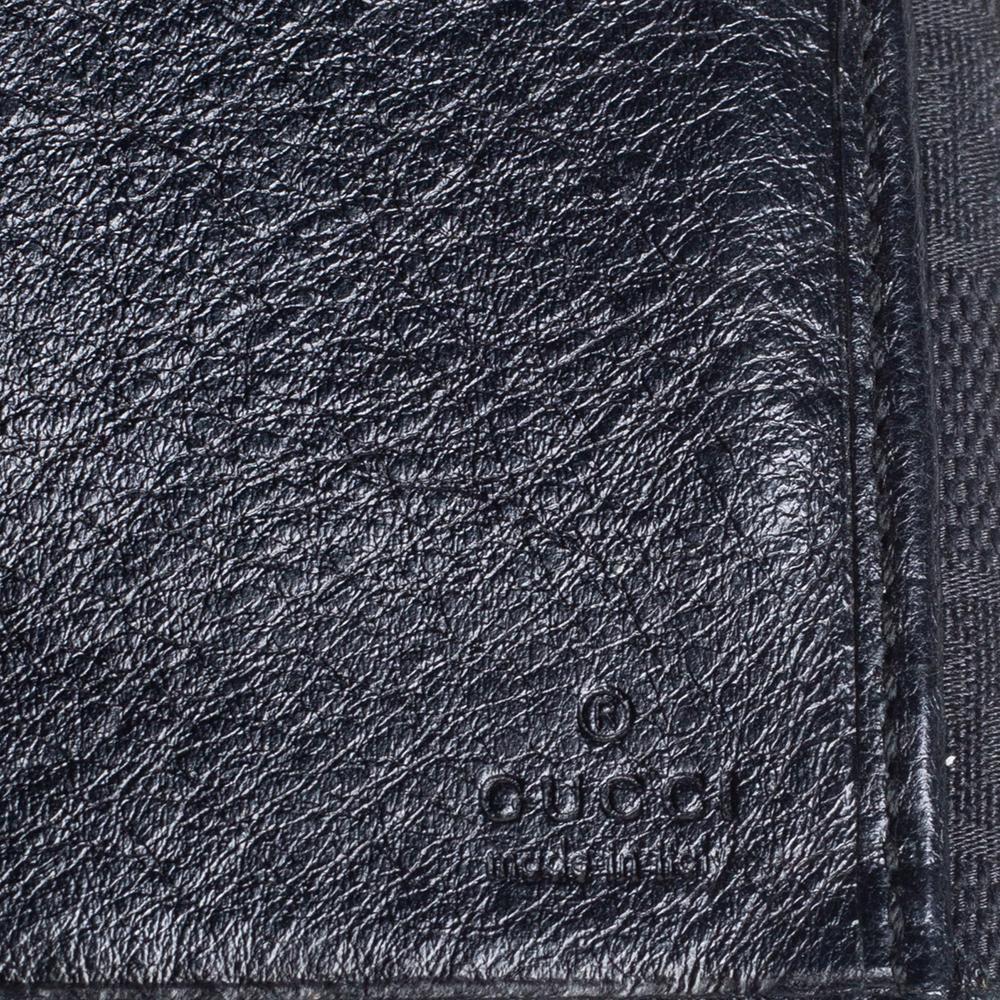 Brimming with signature details of the House, this wallet from Gucci imparts an iconic touch with a hint of glam. It has been crafted using black GG canvas and leather on the exterior, with gold-toned hardware completing its fittings. It has a