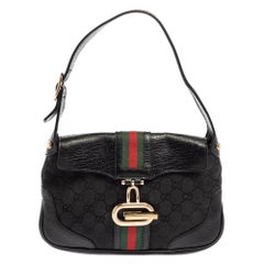 Gucci Schwarze GG Umhängetasche aus Canvas und Leder mit G-Schnalle