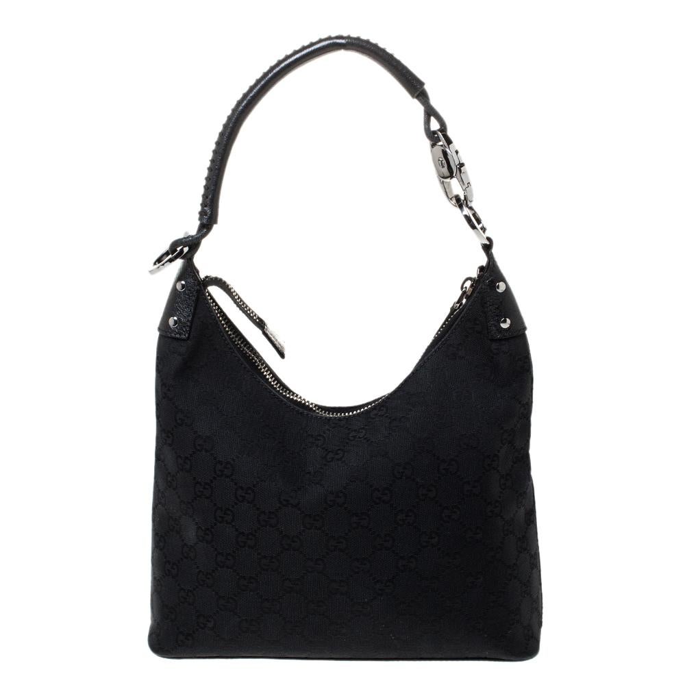 This Gucci hobo bag is a timeless creation that will give you style points season after season. Crafted from the brand's signature GG canvas and leather, this luxurious bag comes in a classic shade of black. It is styled with a single shoulder strap