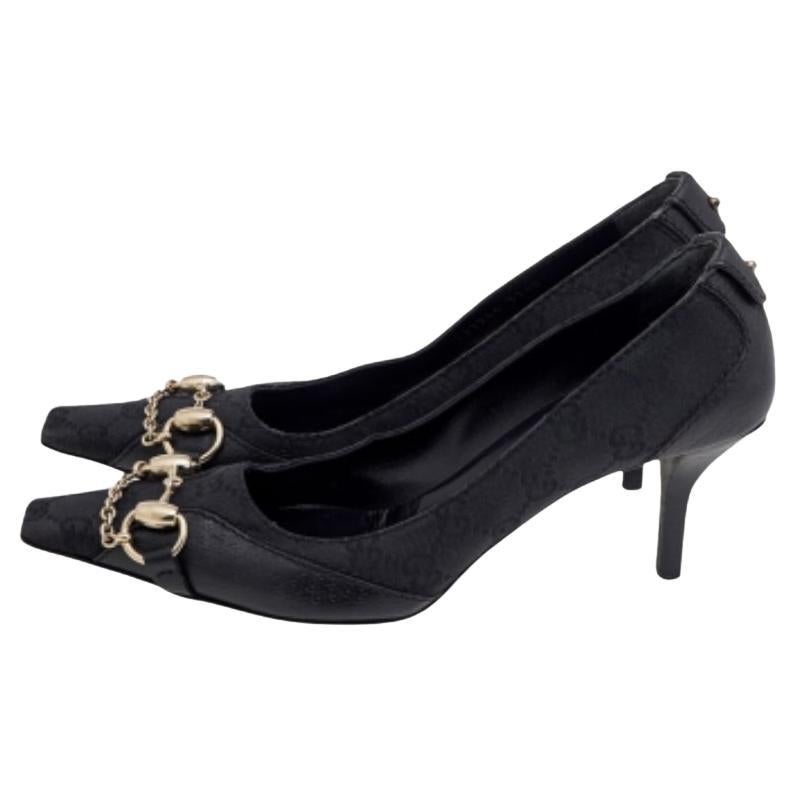 Exprimez l'élégance et la perfection en chaussant ces escarpins de la maison Gucci. Elles sont réalisées en toile GG noire et en cuir sur l'extérieur, avec un motif Horsebit doré fixé sur les orteils. Ils sont montés sur des talons de 7.5 cm. Portez