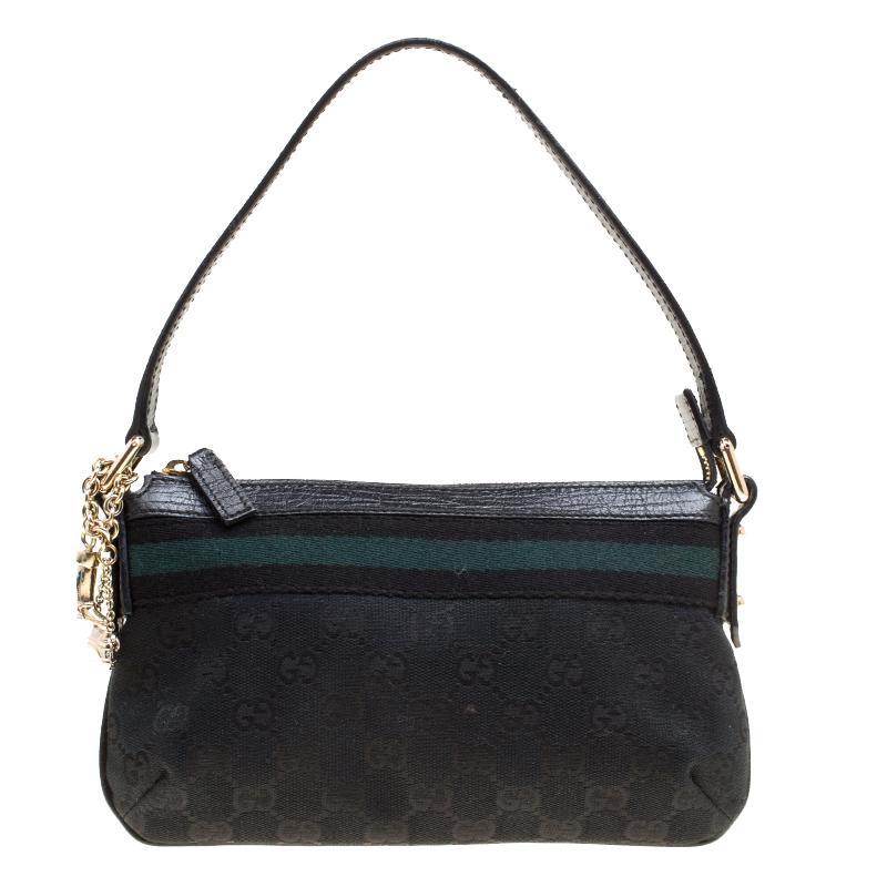 This cute pochette from Gucci is crafted from their signature GG canvas. With green and black web strap detailing, a top handle and gold-tone hardware, there is a lot jam-packed into this small pochette. The top zipper opens to a fabric lined