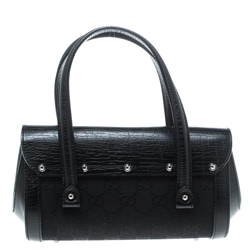 Bags from Gucci are on every woman's wishlist. So, own this gorgeous Bamboo Bullet satchel today and light up your closet! Crafted from signature GG canvas and leather, this stunning black number has a front flap-over lock closure and opens to a