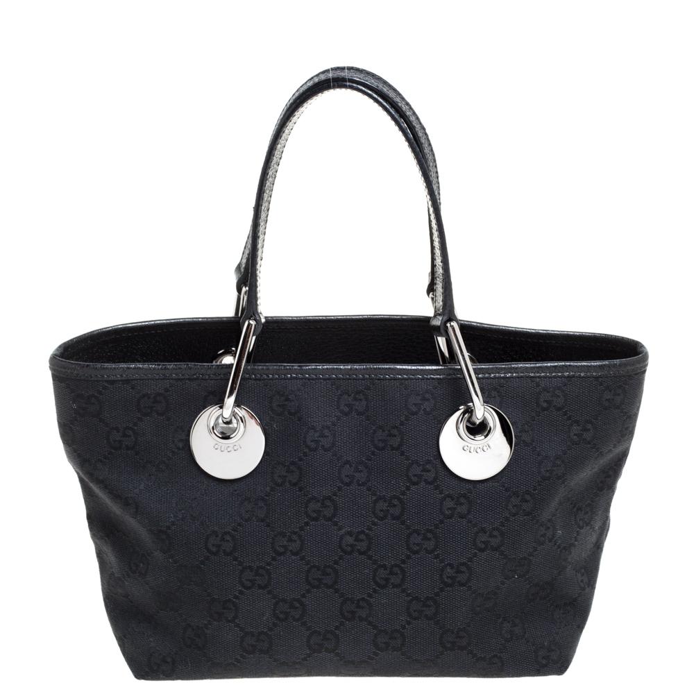 High in appeal and style, this Mini Eclipse tote is a Gucci creation. It has been crafted from GG canvas and leather in Italy and shaped to exude class and luxury. The black bag comes with two handles, a fabric-lined interior, and silver-tone