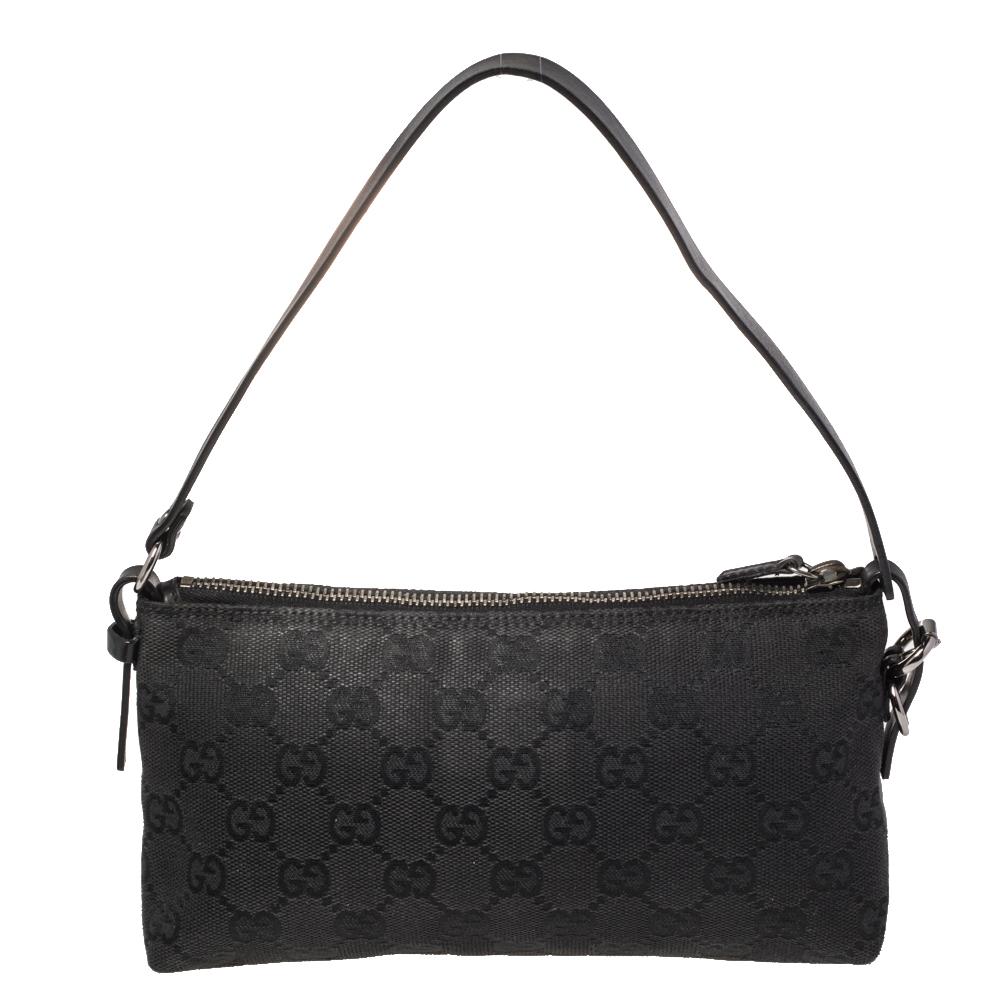 This handy Pochette bag is from the house of Gucci. It has been crafted in Italy and made from signature GG canvas. It comes in a black hue. It is equipped with a fabric interior that will house the essentials you cannot do without. The pochette is